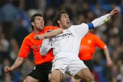 Marchena y Raúl disputan la posición antes de un balón aéreo.